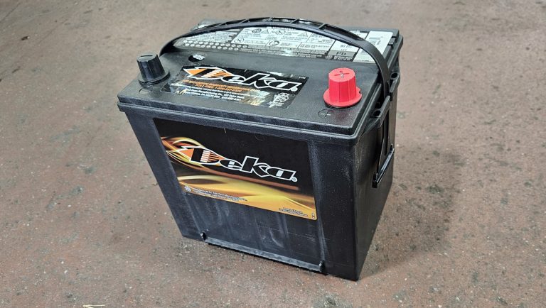 A replacement 12v battery sitting on the floor.
