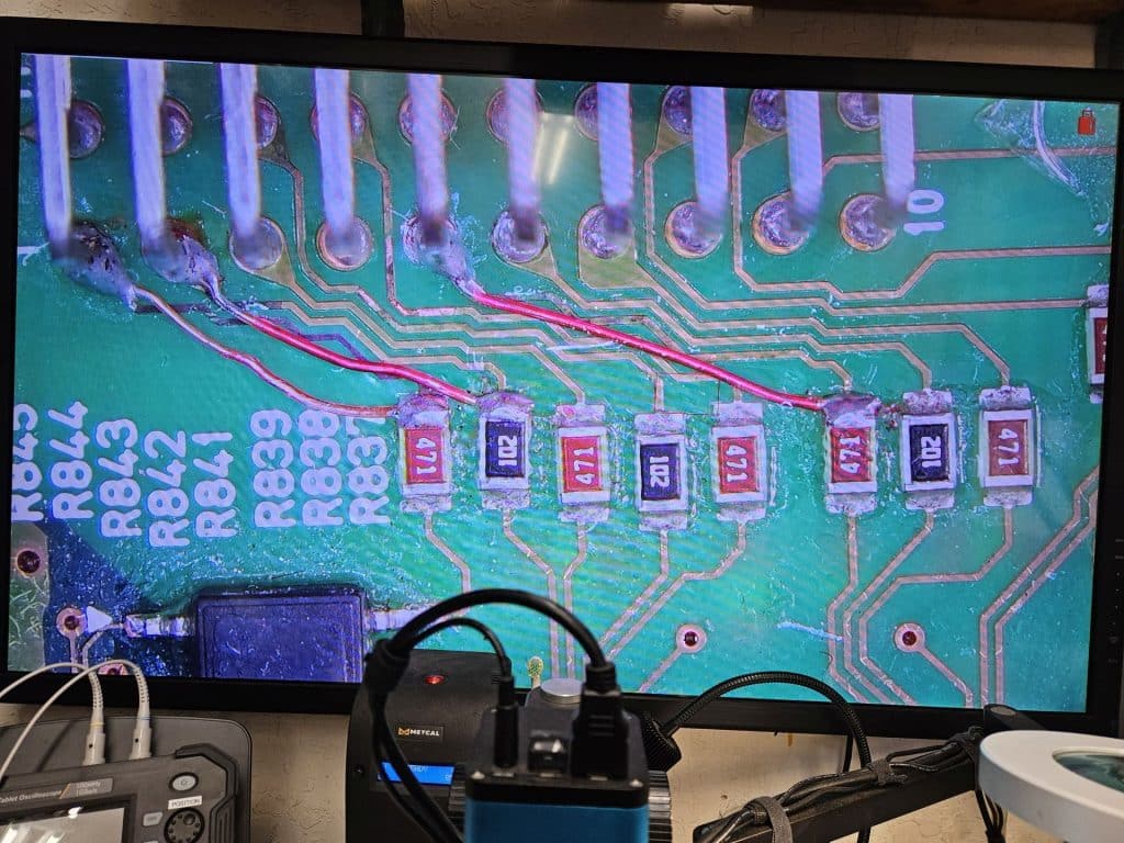 A picture of a circuit board with three jumpers going from three different pins to three different resistors.