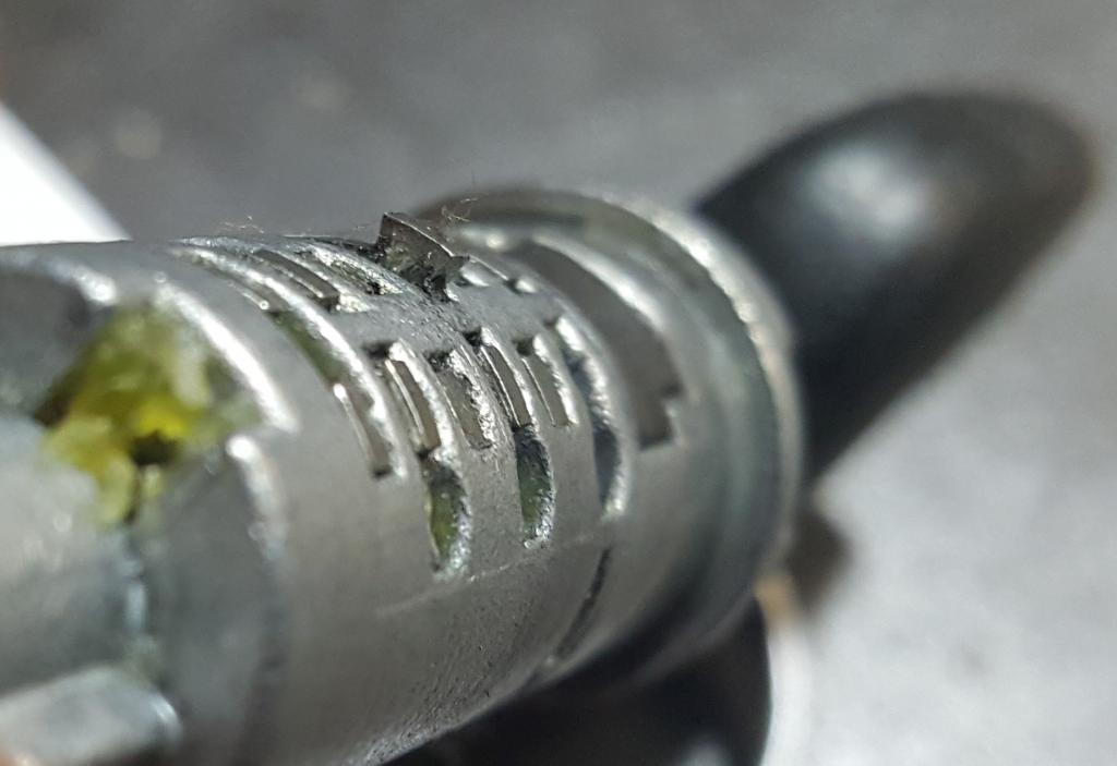 A lock cylinder slug with a single wafer poking up with the key instsalled