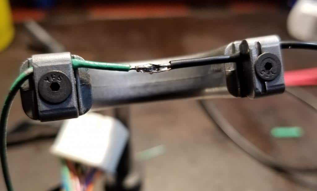 One wire being butt soldered to another in a fixture