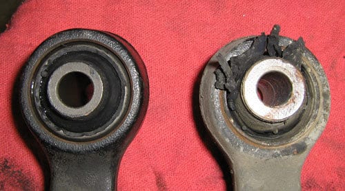 Two control arms. One with a worn out bushing, the other with a new bushing.