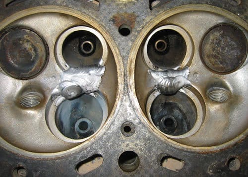 aluminum cylinder head with cracks between valve seats welded