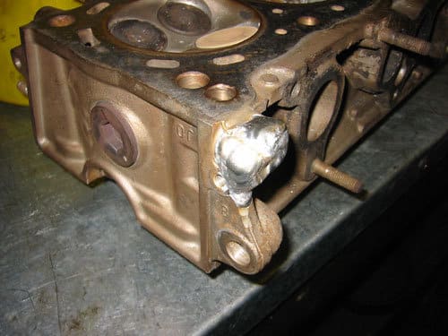 aluminum cylinder head with weld buildup on previously broken lug