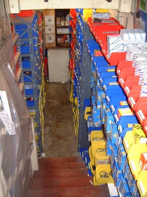 shelving and parts bins lining a stairway