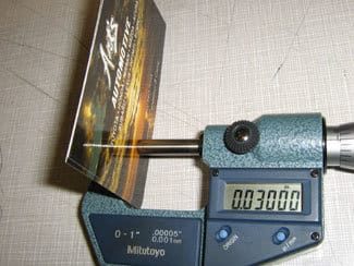 Micrometer measuring a business card