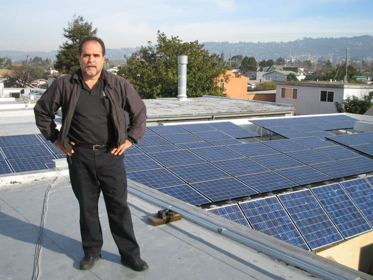 Art standing proudly in front of the newly installed solar system