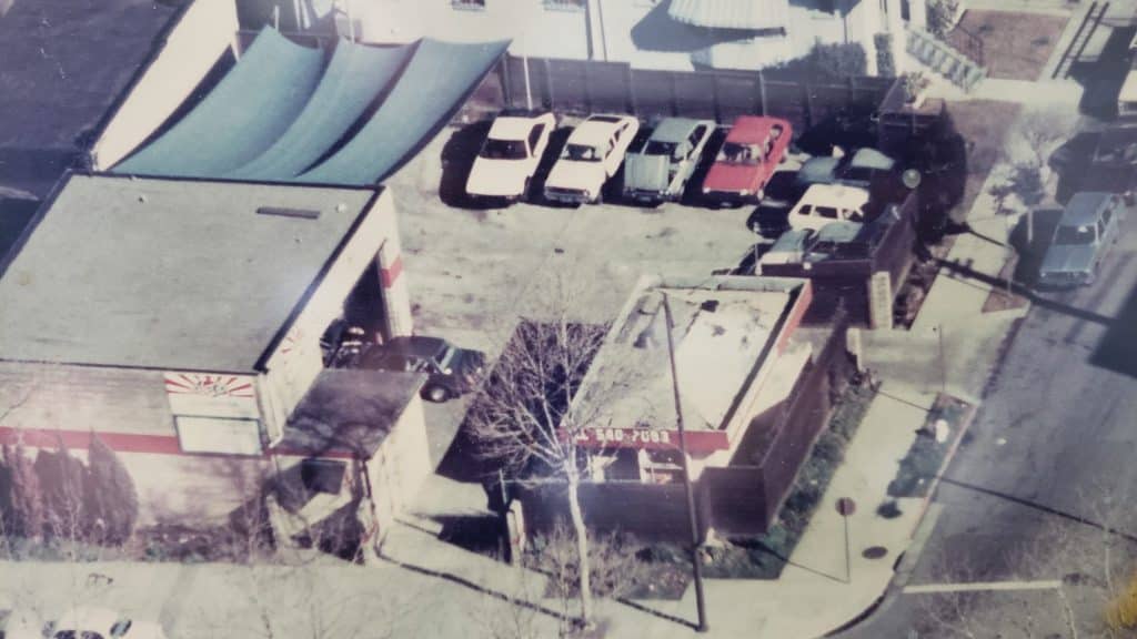 An ariel view of Art's Automotive from 1985 with vintage Japanese cars