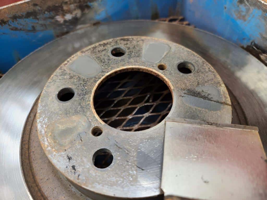 scraping corrosion from rotor hub face surface