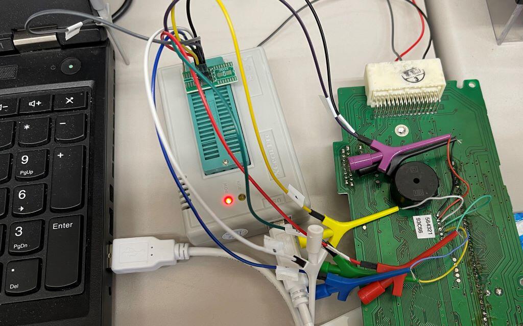 A circuit board with leads soldered to it to connect it to an EEPROM programmer.