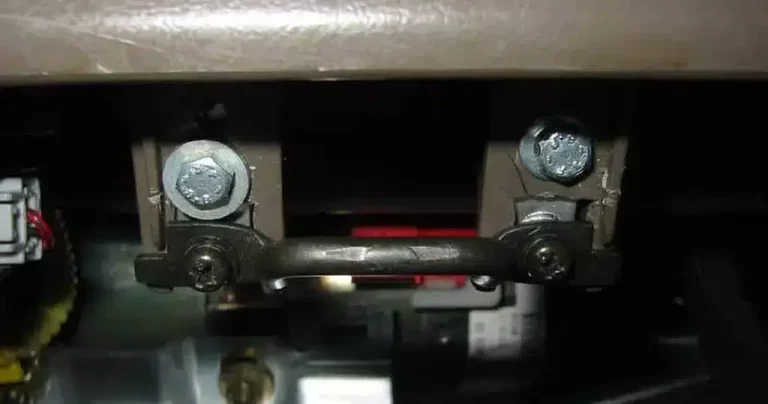 A close up of a repaired glove box striker