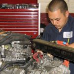 An automotive technician servicing a Toyota hybrid.