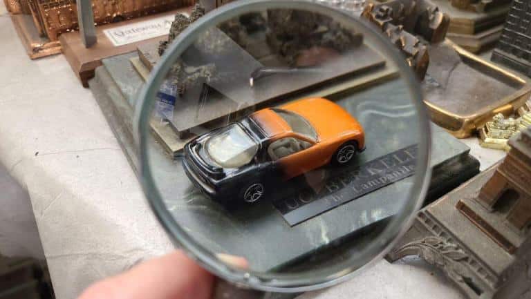 Hotwheels car being inspected with an magnifying glass