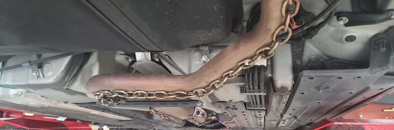 A catalytic converter with thick chain welded to it.