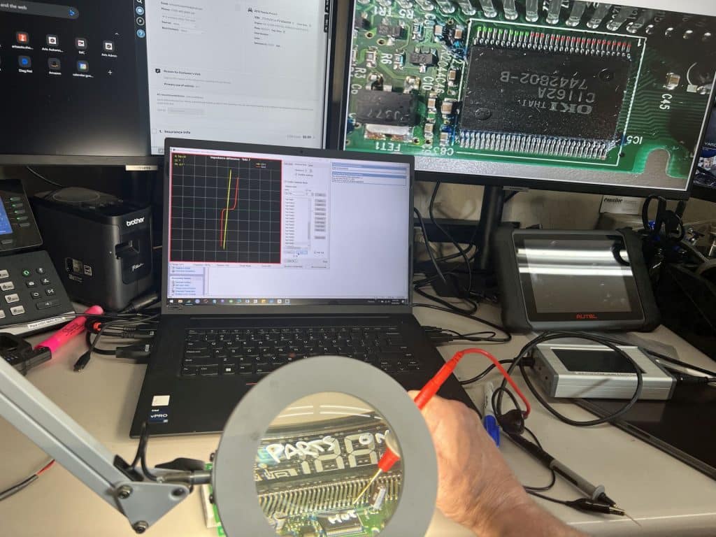 A curve tracer in action! A chip on an electronic component in for repair is shown with test points labeled in red (no pass) and green (pass).