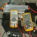 Two voltmeters taking measurements on a DC-DC converter.