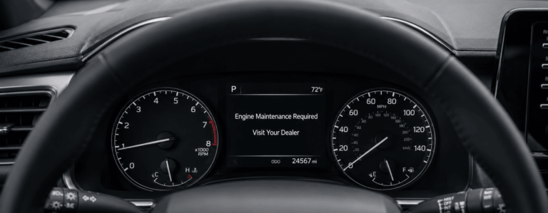 Toyota dashboard displaying “Engine Maintenance Required — Visit Your Dealer”