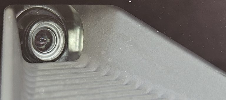 A close up view of a Honda multi-purpose ADAS camera behind a windshield.