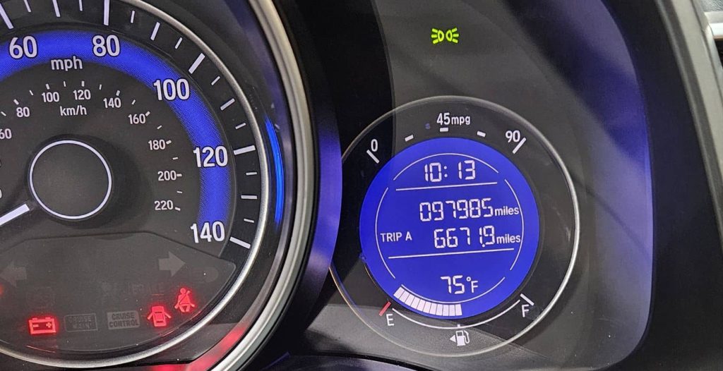 An image of a Honda Fit speedometer with an LCD display containing the odometer and the fuel gauge.