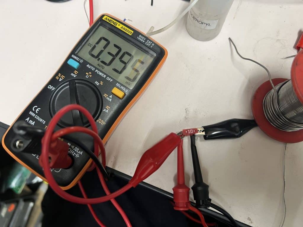 A voltmeter measuring .395V across a 10A fuse.