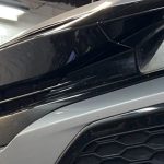 A banner image with a Honda on a lift being repaired.