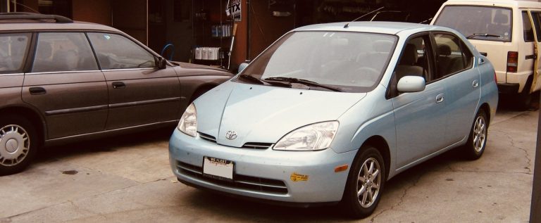 A first generation Prius hybrid parked in the yard after repair at Art's Automotive in Berkeley.