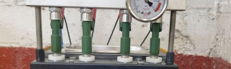 Injectors mounted in a cleaning machine for flow testing.