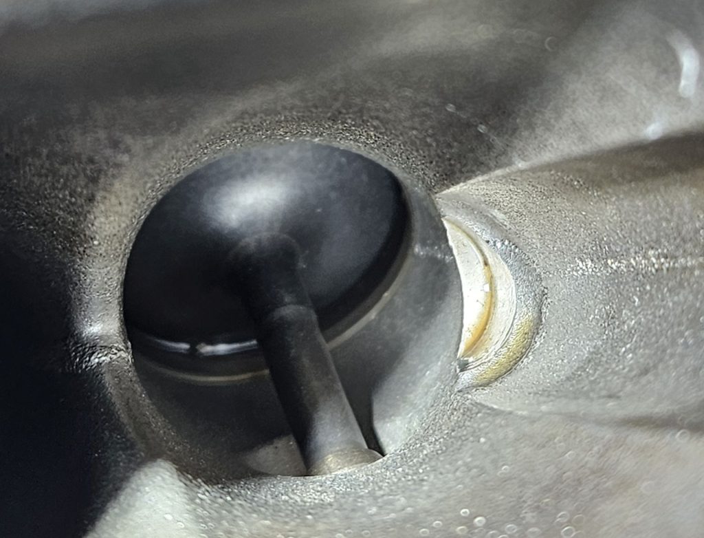 A image of a clean intake valve after walnut shell blasting.