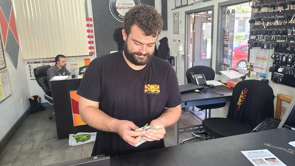 How much does it cost to repair car A/C? Just look at this picture of a smiling mechanic counting his cash after a car air conditioner repair!