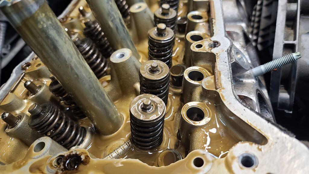 cylinder headcoated with coffee and cream colored oil