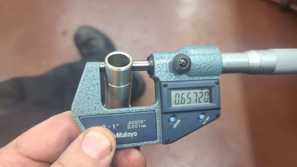 a digital micrometer displaying 0.6572" measuring the finished nipple