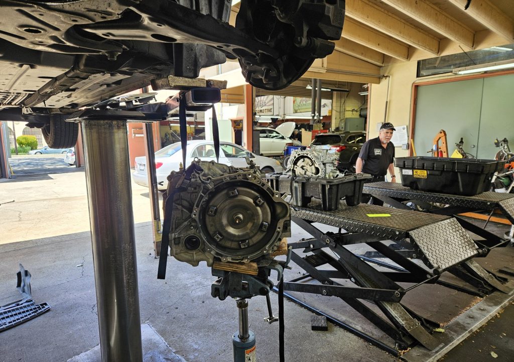 A used Toyota CVT transmission in the foreground and a rebuilt CVT transmission in the background. 