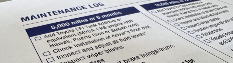 Close up of a Toyota scheduled maintenance guide book.