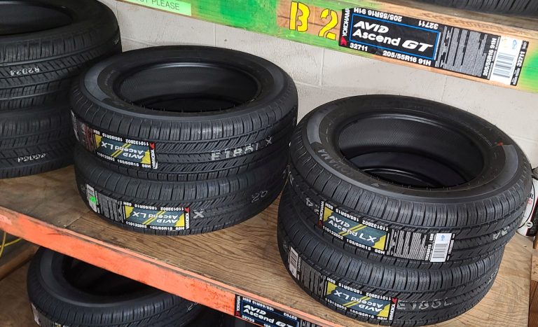 New tires sitting on a shelf.