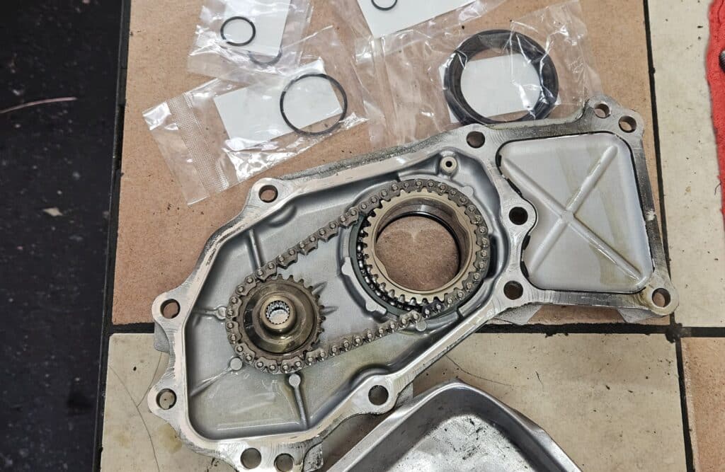 The CVT oil pump cover and chain along with the replacement seal and o-rings.
