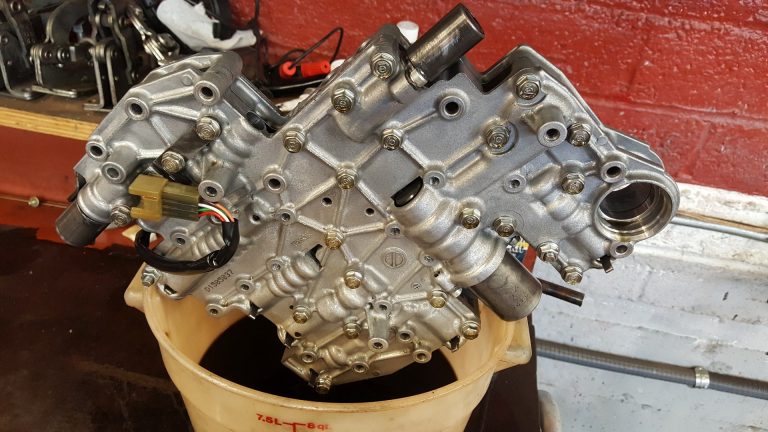 A valve body removed to repair a Subaru transmission.