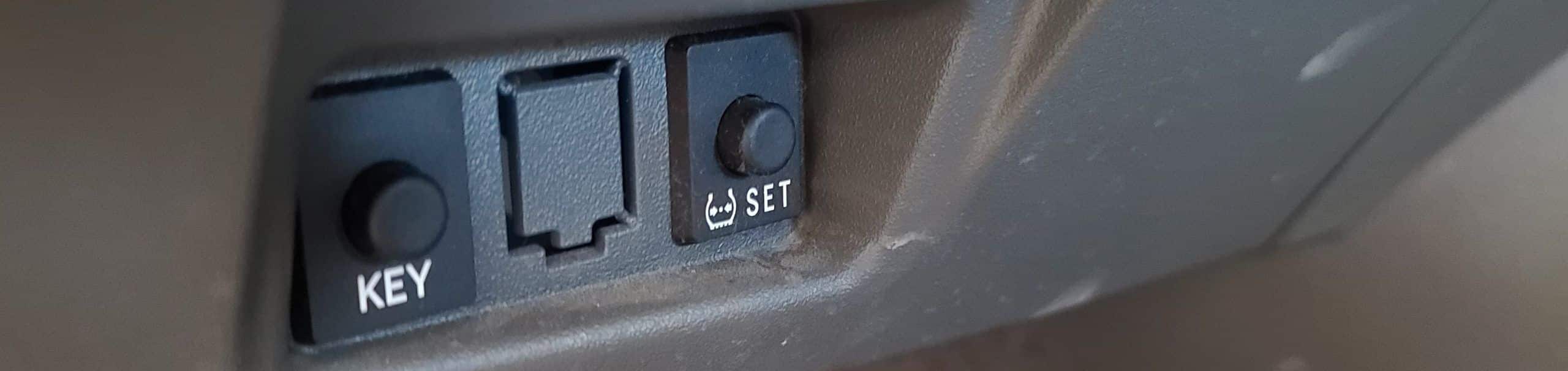 Tire pressure light reset button on lower dashboard, Toyota Prius