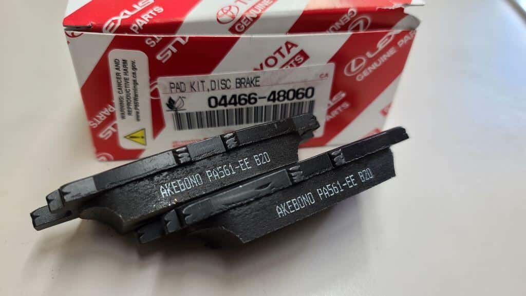 Toyota brake pads next to a Toyota box. The pads have "Akebono" printed on them.