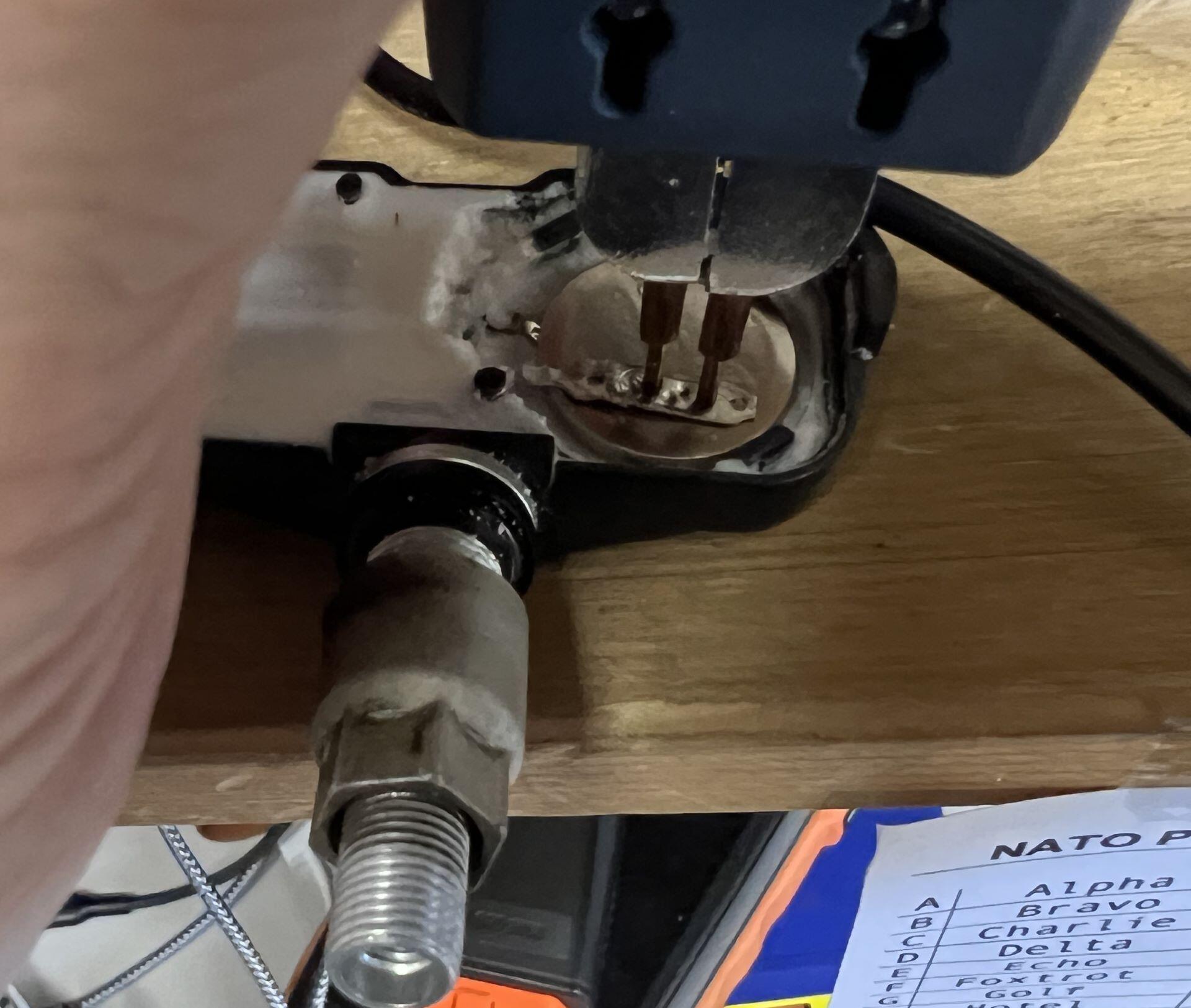 Spot welding the TPMS sensor battery to the sensor strap with strap welder.