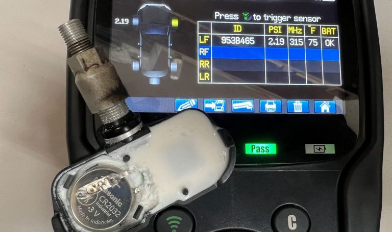 A TPMS sensor with a replacement battery installed.