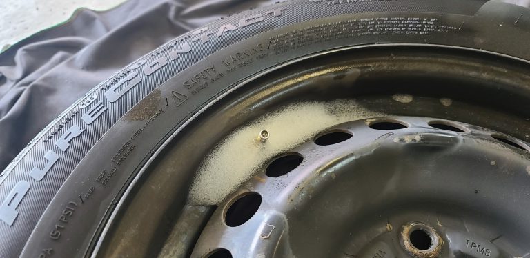 A tire with leak detector spray bubbling around the TPMS sensor.