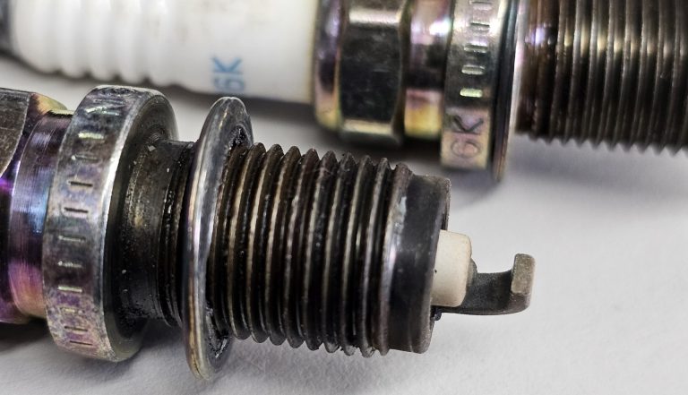A close up of a worn spark plug