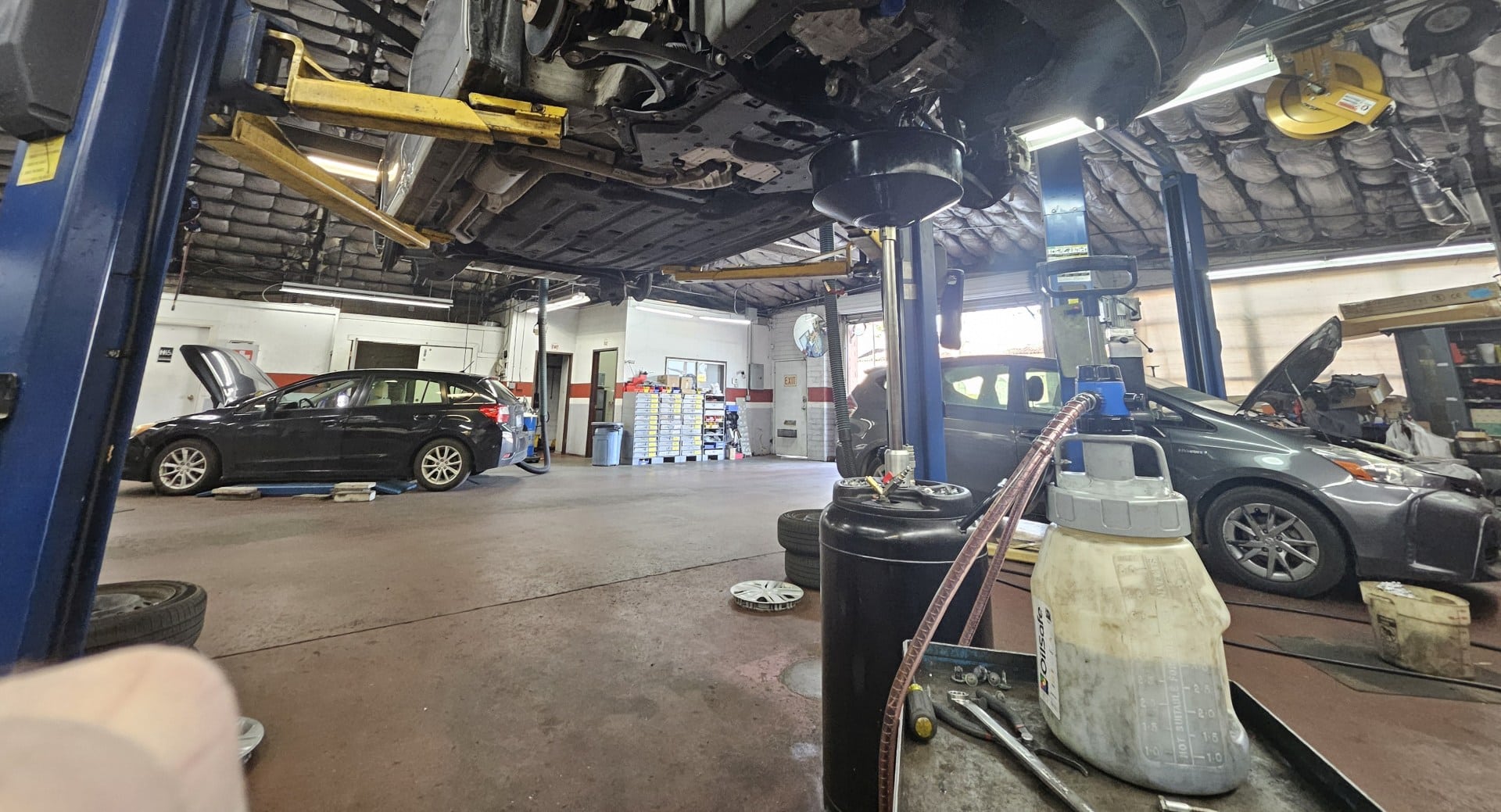 Transmission fluid draining with a fresh transmission fluid pump in the foreground.