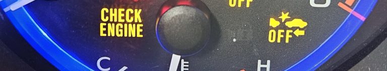 A close up of a check engine light on a dashboard.